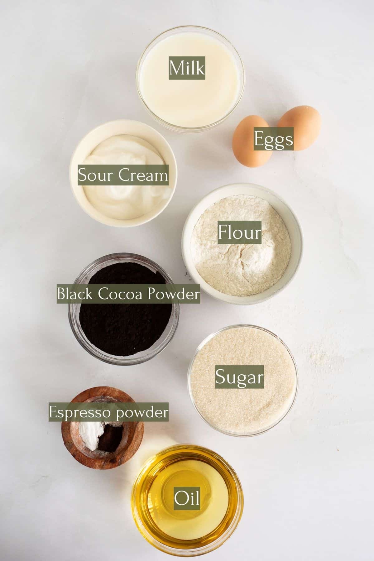 ingredients to make black velvet cupcakes labeled with green text boxes.
