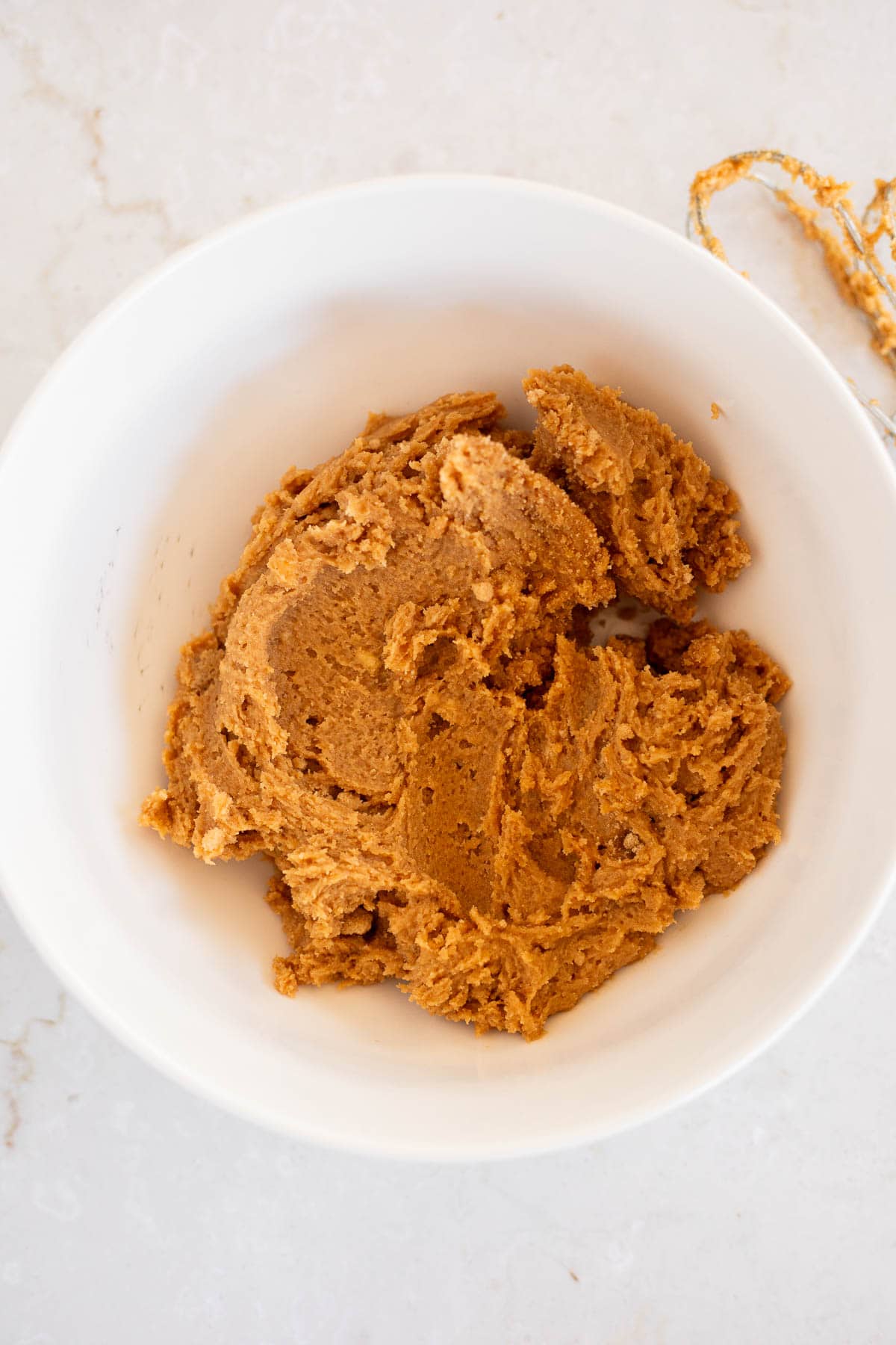 butter, peanut butter, and brown sugar mixed together in a white bowl.