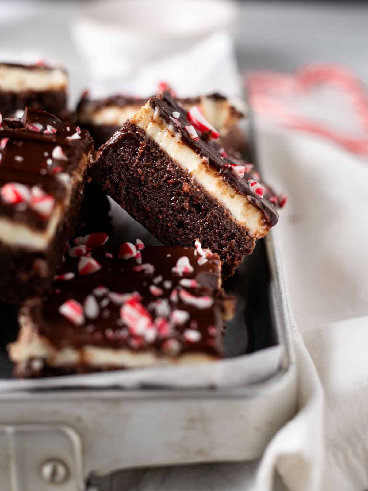 Peppermint Bark Brownies in a metal pan lined with parchment paper.