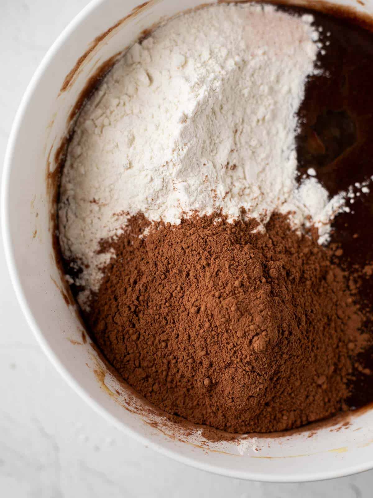 flour and cocoa powder in a bowl of brownie batter.
