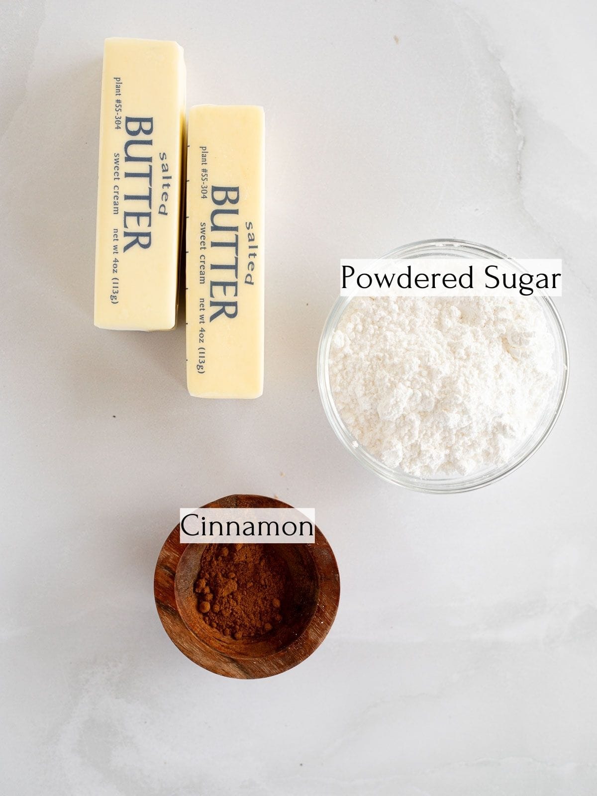 ingredients to make cinnamon buttercream labeled with white text boxes.