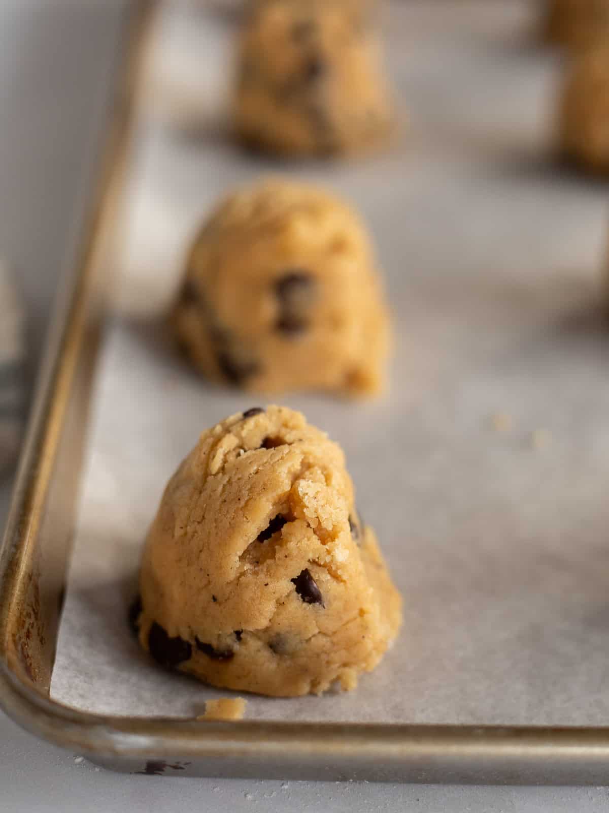 tall mounds of raw chocolate chip cookie dough with brown butter.