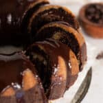 Three chocolate glazed marble bundt cake slices on parchment paper.