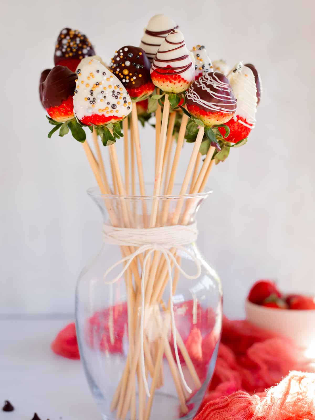 a homemade chocolate covered strawberry bouquet in a glass vase.