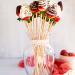 a DIY chocolate covered strawberry bouquet in a glass vase.