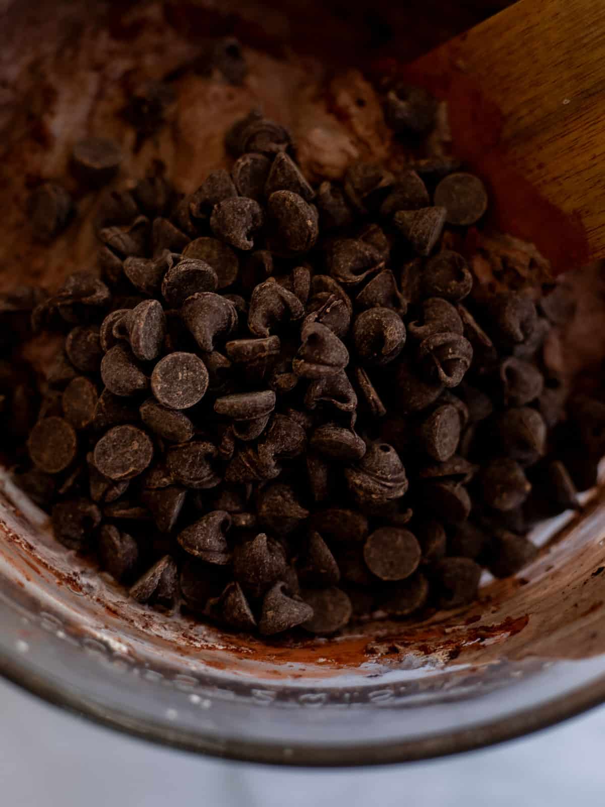 dark chocolate chips in a bowl of no-churn chocolate ice cream base.