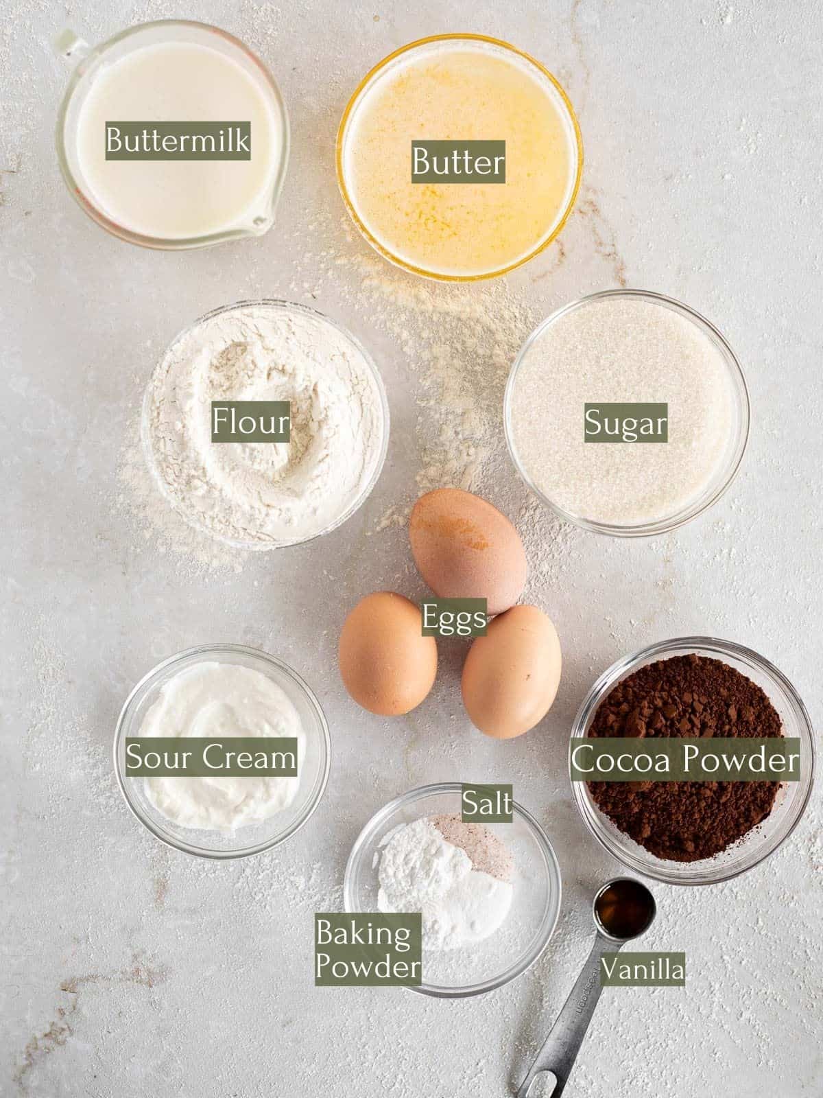 Ingredients to make a buttermilk marble bundt cake labeled with green text boxes and white text.
