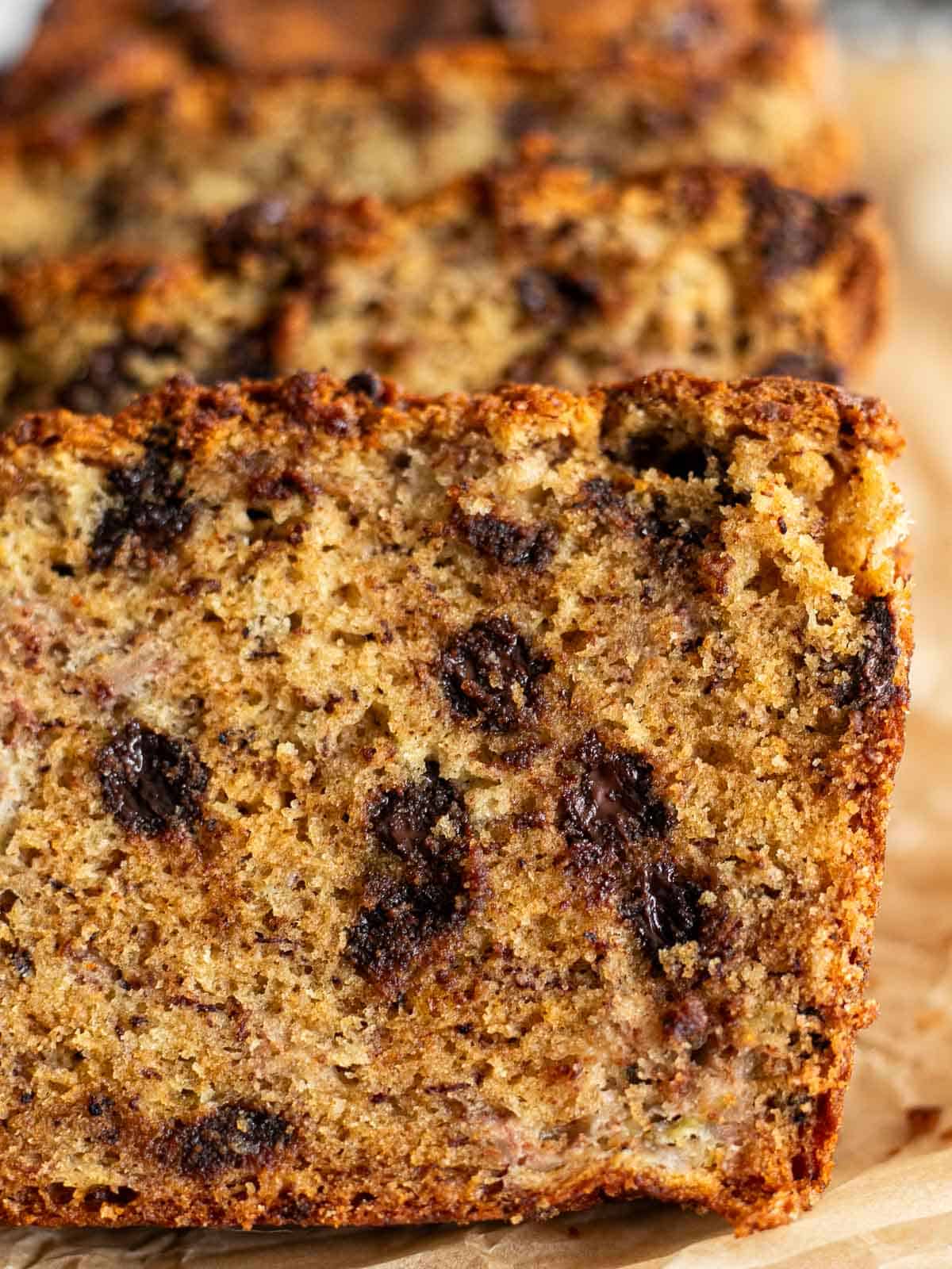 macro shot of the texture of a slice of brown butter banana bread with chocolate chips.