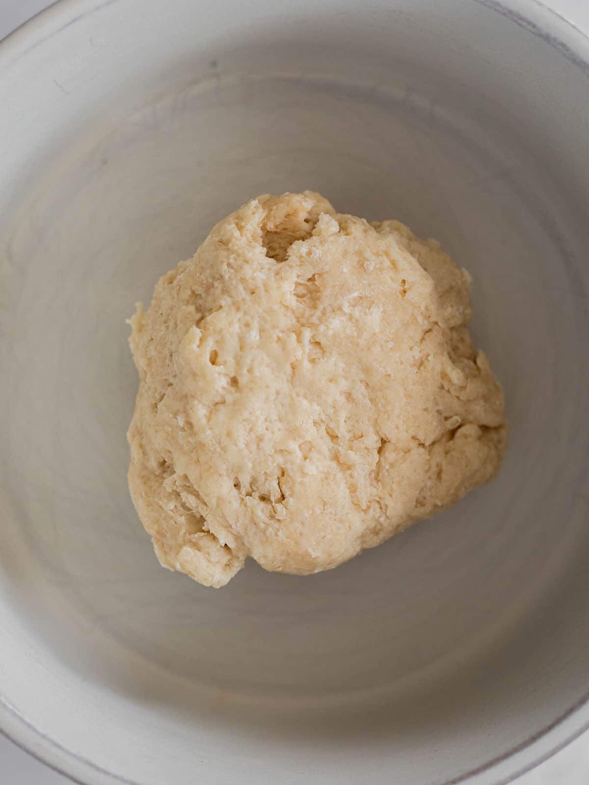 dough for a single cinnamon roll in a white bowl.