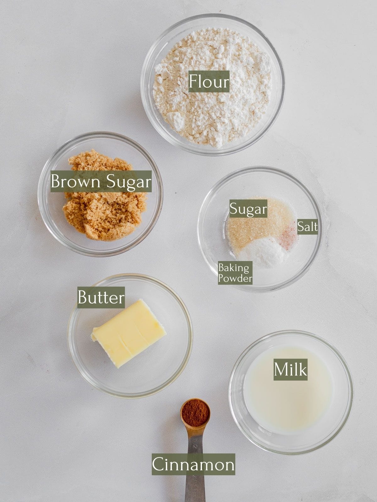 ingredients to make a single cinnamon roll labeled with green text.